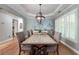Dining room with a large table and rustic chandelier with hardwood floors and natural light at 2825 Lake Ct, Cumming, GA 30041
