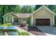 Charming one-story home with manicured landscaping, a two-car garage, and views of the lake at 2825 Lake Ct, Cumming, GA 30041