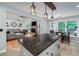 Open concept kitchen with granite counters, stainless appliances, and view of fireplace and living room at 2825 Lake Ct, Cumming, GA 30041