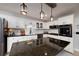 Well-equipped kitchen with white cabinetry and stainless steel appliances and a large island at 2825 Lake Ct, Cumming, GA 30041