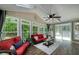 Cozy sunroom with many windows to bring in natural light and plush red sofas at 2825 Lake Ct, Cumming, GA 30041