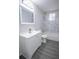 Modern bathroom featuring a vanity with sink, toilet, and bathtub/shower combo with marble-look tiled walls at 3893 Bonnie Se Ln, Atlanta, GA 30354