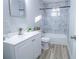 Bright bathroom featuring a vanity, toilet, and tub/shower combo with tiled walls and modern fixtures at 3893 Bonnie Se Ln, Atlanta, GA 30354