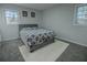Bedroom featuring a plush bed with a patterned comforter, soft carpet, and dual windows for plenty of light at 3893 Bonnie Se Ln, Atlanta, GA 30354