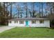 Charming brick ranch with a striking turquoise door and well-manicured lawn at 3893 Bonnie Se Ln, Atlanta, GA 30354