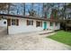 Charming ranch home with a turquoise door, a long driveway, and manicured lawn at 3893 Bonnie Se Ln, Atlanta, GA 30354