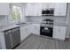 New kitchen featuring white cabinets, stainless steel appliances, and granite countertops at 3893 Bonnie Se Ln, Atlanta, GA 30354