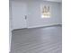 Well-lit room with gray floors, neutral paint, doors, and a bright window at 3893 Bonnie Se Ln, Atlanta, GA 30354