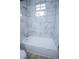 Marble tiled shower with a white bathtub and a window at 3893 Bonnie Se Ln, Atlanta, GA 30354