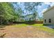 Large backyard with green grass, mature trees, and a view of the back of the house at 7250 Old Chapel, Atlanta, GA 30349