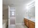 Bathroom with double sink vanity, large mirror, bathtub, and view to a bedroom at 7250 Old Chapel, Atlanta, GA 30349