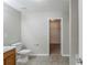 Clean bathroom with a standard toilet, neutral walls and flooring, and a view to the closet at 7250 Old Chapel, Atlanta, GA 30349