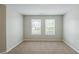 Neutral-toned bedroom with two windows and plush carpeting, offering a serene and comfortable space at 7250 Old Chapel, Atlanta, GA 30349