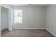 Neutral-toned bedroom with a window and a closet door, and plush carpeting, offering a serene space at 7250 Old Chapel, Atlanta, GA 30349