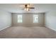 Neutral-toned bedroom with plush carpeting and two windows with blinds, offering a serene and relaxing retreat at 7250 Old Chapel, Atlanta, GA 30349