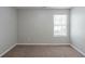 Neutral bedroom featuring plush carpet, a window with blinds, and soft paint, offering a relaxing retreat at 7250 Old Chapel, Atlanta, GA 30349