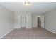 Neutral bedroom with a double closet and doorway. The plush carpeting offering comfortable flooring at 7250 Old Chapel, Atlanta, GA 30349