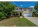 Charming two-story home with a well-manicured lawn and a two car garage at 7250 Old Chapel, Atlanta, GA 30349
