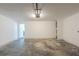 Empty two car garage with a concrete floor and an entrance to the house on the back wall at 7250 Old Chapel, Atlanta, GA 30349