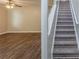 Living room features luxury vinyl plank flooring adjacent to carpeted stairway at 7250 Old Chapel, Atlanta, GA 30349