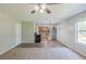 Bright living room featuring neutral paint, ceiling fan, leading into kitchen with stainless steel appliances and wood floors at 7250 Old Chapel, Atlanta, GA 30349