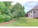 Spacious backyard with a manicured lawn and lush green landscaping, perfect for outdoor activities at 764 Morganton Dr, Johns Creek, GA 30024