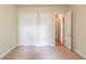 Carpeted bedroom featuring two large closets, cream colored walls, and simple features; a blank canvas at 764 Morganton Dr, Johns Creek, GA 30024