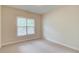 Neutral bedroom with window, carpet, cream colored walls, and simple features; ready for personalized touches at 764 Morganton Dr, Johns Creek, GA 30024