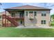 Exterior of home with a spacious backyard, porch, and wooden staircase, combining comfort and nature at 764 Morganton Dr, Johns Creek, GA 30024