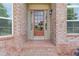 Close-up of a brick home's front door with glass panels and sidelights for a welcoming entrance at 764 Morganton Dr, Johns Creek, GA 30024