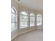 Bright living room with arched windows allowing natural light to fill the space at 764 Morganton Dr, Johns Creek, GA 30024