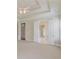 Open bedroom with neutral carpet, crown molding, a ceiling fan and open doors to bathrooms and closets at 764 Morganton Dr, Johns Creek, GA 30024