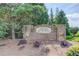 Welcoming 'Jaden Woods' brick neighborhood entrance with manicured landscaping and mature trees at 764 Morganton Dr, Johns Creek, GA 30024