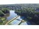 Aerial view featuring tennis courts, a lake, and lush greenery surrounding the community at 100 Pine Mist Cir, Alpharetta, GA 30022
