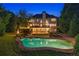 Stunning backyard oasis with a sparkling pool, spacious deck, and lush landscaping at 100 Pine Mist Cir, Alpharetta, GA 30022
