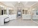 An expansive bathroom is presented, showcasing double vanities and mirrors, all finished with neutral, classic tones at 100 Pine Mist Cir, Alpharetta, GA 30022