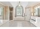 Luxury bathroom featuring a soaking tub, a separate glass shower, and dual vanities with ample counter space at 100 Pine Mist Cir, Alpharetta, GA 30022