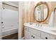 Classic bathroom featuring white cabinets, an oval mirror, and a shower-tub combination with white tile surround at 100 Pine Mist Cir, Alpharetta, GA 30022
