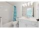 Bright bathroom featuring a shower/tub combo, white cabinets and a large mirror at 100 Pine Mist Cir, Alpharetta, GA 30022