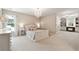 Spacious bedroom with chandelier lighting, plush carpet, and windows overlooking the backyard at 100 Pine Mist Cir, Alpharetta, GA 30022