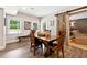 Charming dining area features wood floors, sliding barn door, and natural light from multiple windows at 100 Pine Mist Cir, Alpharetta, GA 30022