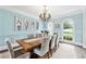 Elegant dining room features natural light, a rustic table, and stylish seating at 100 Pine Mist Cir, Alpharetta, GA 30022