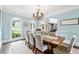 Elegant dining room with light blue walls and views of the landscaped yard at 100 Pine Mist Cir, Alpharetta, GA 30022