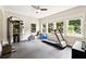Bright exercise room featuring large windows, a treadmill and weight-lifting equipment at 100 Pine Mist Cir, Alpharetta, GA 30022