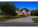 Charming two-story home with a well-manicured lawn, driveway, and mature trees at 100 Pine Mist Cir, Alpharetta, GA 30022