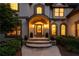 Arched front entry way with keystone accents and a multi-tiered stone stairway at 100 Pine Mist Cir, Alpharetta, GA 30022