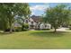 Beautiful two-story home with lush green lawn and meticulously manicured landscaping at 100 Pine Mist Cir, Alpharetta, GA 30022