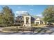 Stately home featuring a circular driveway, fountain, manicured landscaping, and covered porch at 100 Pine Mist Cir, Alpharetta, GA 30022