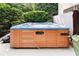 Outdoor hot tub featuring wood paneling and privacy landscaping at 100 Pine Mist Cir, Alpharetta, GA 30022
