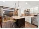 Modern kitchen features a marble island with seating, stainless steel appliances and decorative backsplash at 100 Pine Mist Cir, Alpharetta, GA 30022